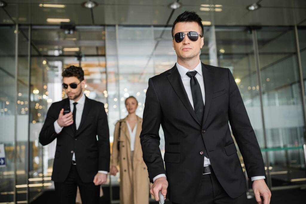 private security service, personal safety concept, handsome bodyguards in formal wear and sunglasses